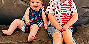 Jemma joined the competition — help win amazing prizes! baby, blue, boots, boy, child, clothing, couch, cute, face, furniture, happy, headband, indoor, pattern, person, red, shorts, sitting, smile, toddler