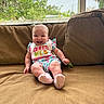 baby, child, smiling, sitting, couch, bib, colorful_clothing, indoor, window, greenery, pacifier, happy, face, infant, person, furniture, cute, home, cozy, portrait