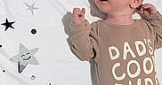 James joined the competition — help win amazing prizes! baby, infant, one_month, onesie, clothing, cute, stars, clouds, blanket, smiling, happy, lying_down, child, newborn, face, expression, indoors, soft_lighting, adorable, portrait