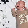 James joined the competition — help win amazing prizes! adorable, baby, blanket, child, clothing, clouds, cute, expression, face, happy, indoors, infant, lying_down, newborn, one_month, onesie, portrait, smiling, soft_lighting, stars