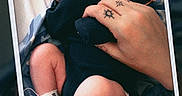 James is registered to the contest to win money with this photo: baby, bed, blanket, closeup, cute, date, hand, hospital, infant, medical_tube, newborn, peaceful, person, polaroid, rest, skin, sleeping, swaddled, tattoo, tiny