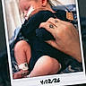 James is registered to the contest to win money with this photo: newborn, baby, sleeping, hand, tattoo, medical_tube, blanket, hospital, polaroid, date, infant, swaddled, cute, peaceful, skin, person, bed, closeup, rest, tiny