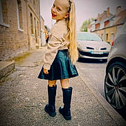 Zaïra participe au concours pour gagner de l'argent avec cette photo : child, girl, smiling, long_hair, street, sidewalk, boots, skirt, sweater, blonde, outdoor, urban, car, buildings, person, fashion, happy, posing, daylight, portrait