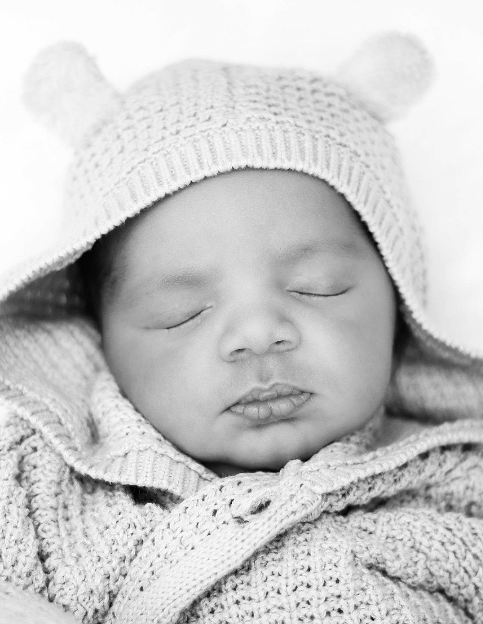 True joined the competition — help win amazing prizes! baby, black_and_white, cheek, child, close_up, eye, face, head, headgear, headwear, knit_cap, lip, monochrome, nose, person, photograph, photography, portrait, portrait_photography, skin