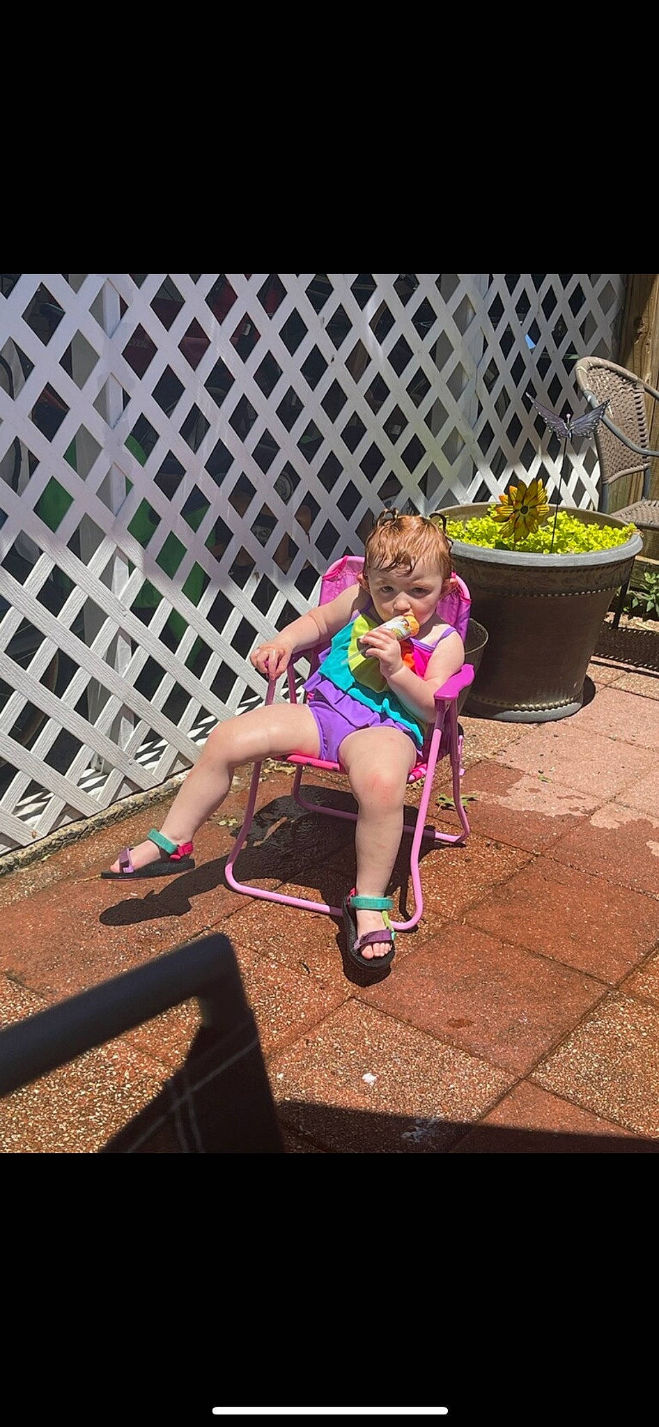 Haisley is registered to the contest to win money with this photo: city, eyewear, fence, flowerpot, foot, footwear, fun, grass, human_leg, leg, leisure, mammal, person, plant, recreation, sandal, shoe, sidewalk, sneakers, thigh