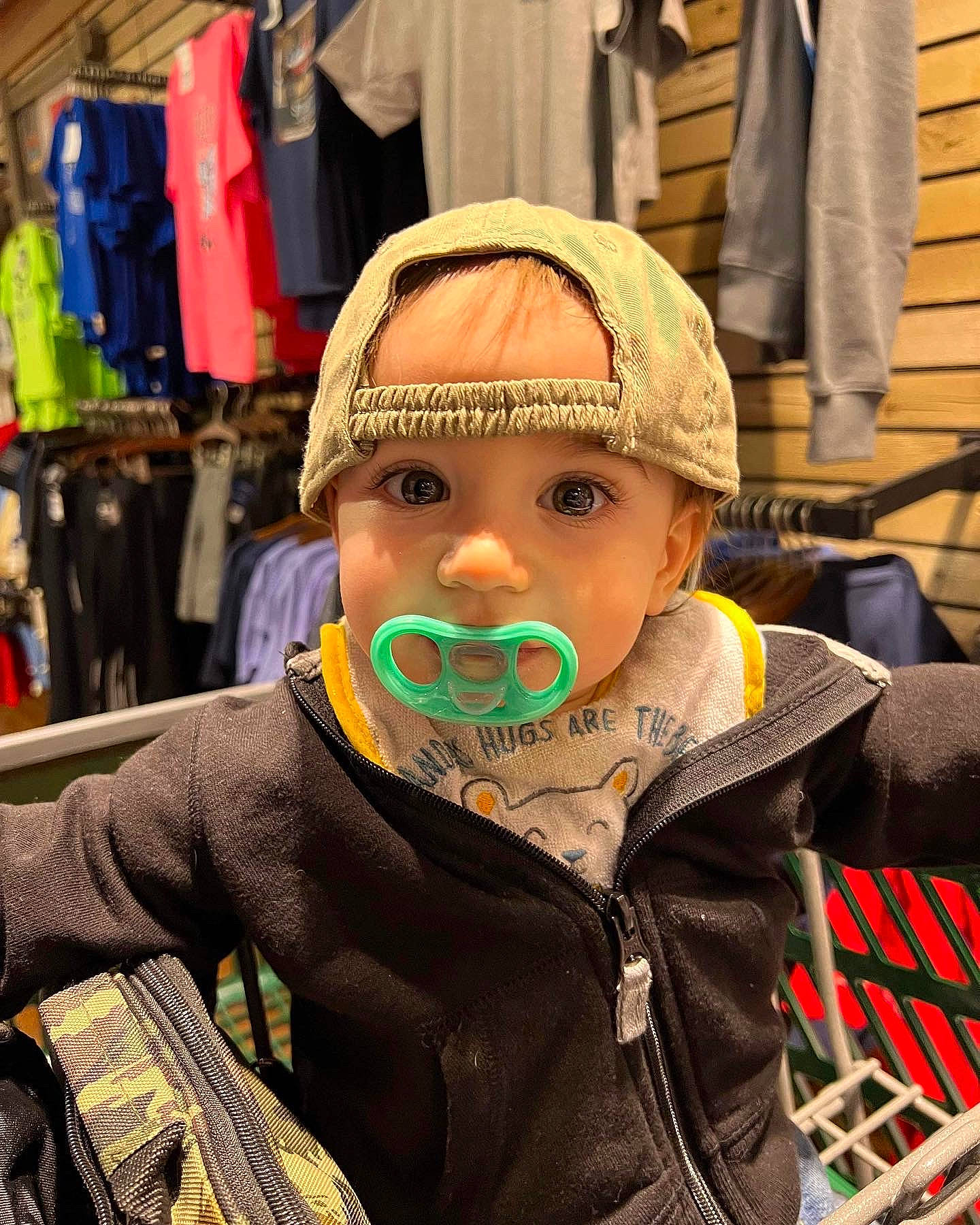 Grayson is registered to the contest to win money with this photo: baby, beard, cap, cheek, child, event, fashion_accessory, happy, headgear, headwear, helmet, holiday, moustache, outerwear, person, personal_protective_equipment, public_space, sitting, street, toddler