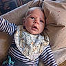 Valentin a rejoint le concours — aidez-le/la à gagner de superbes lots ! baby, bib, blue_jeans, casual, child, comfort, curious_expression, cushion, dogs_pattern, face, head, home, indoor, infant, person, portrait, reaching_hand, soft_fabric, striped_clothing, young_child