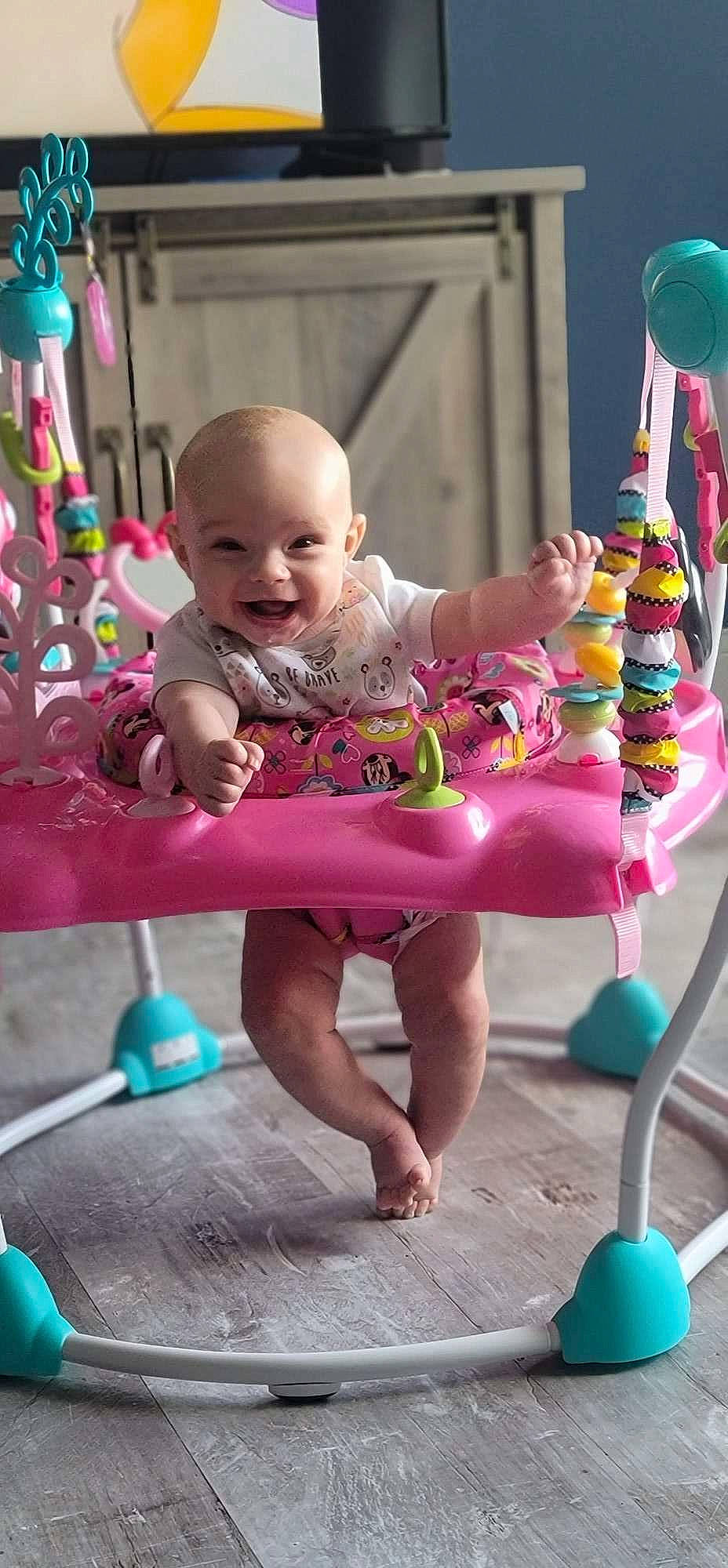 Ila is registered to the contest to win money with this photo: baby, baby_toddler_clothing, blue, child, facial_expression, fun, green, happy, human, joy, leisure, magenta, person, pink, product, purple, red, smile, standing, summer