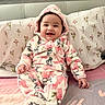 baby, child, smiling, happy, portrait, indoor, bed, pillow, bedding, floral, pink, hood, onesie, fleece, rabbit_pattern, sitting, infant, face, cute, bedroom