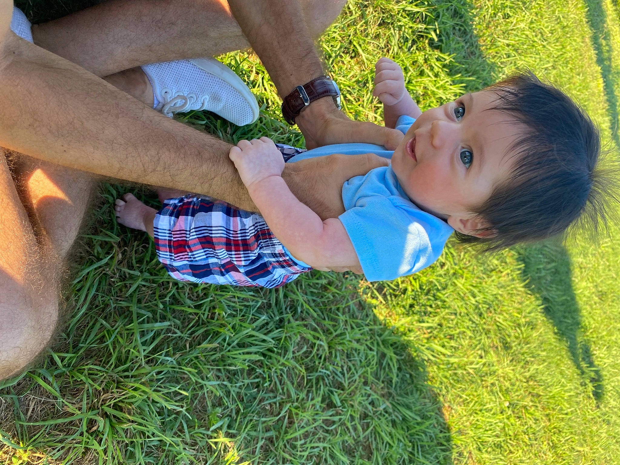 Oliver is registered to the contest to win money with this photo: arm, baby_toddler_clothing, facial_expression, finger, fun, gesture, grass, hairstyle, hand, happy, human_body, leg, leisure, people_in_nature, person, plant, shorts, summer, toddler, tree