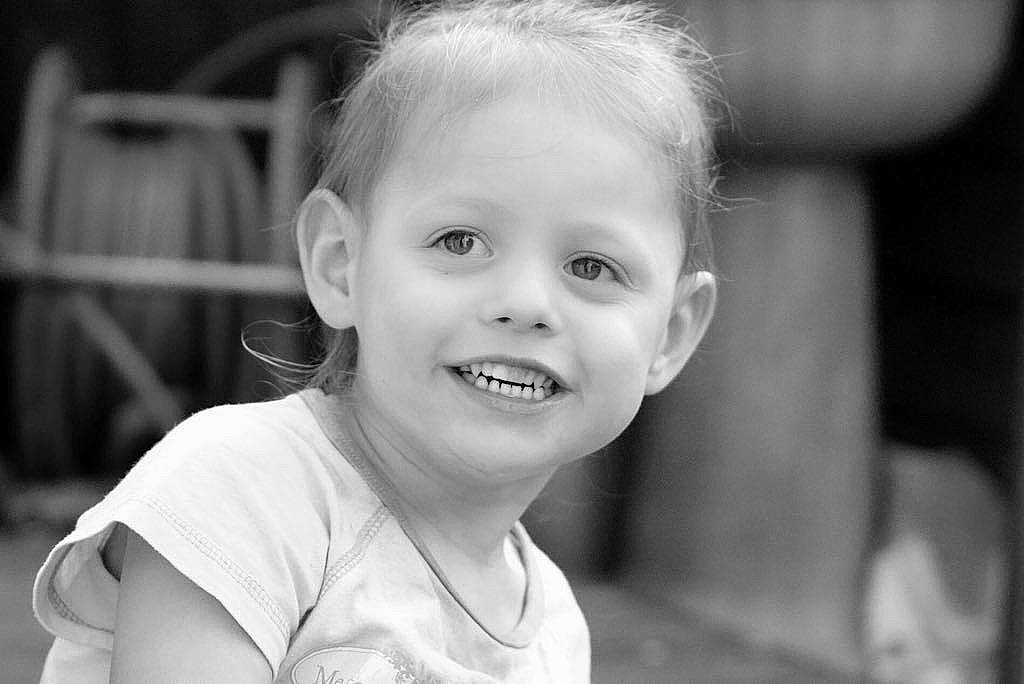 Nicole is registered to the contest to win money with this photo: black, black_and_white, cheek, child, chin, eye, face, facial_expression, hairstyle, head, joy, monochrome, monochrome_photography, organ, people, person, photograph, skin, smile, snapshot