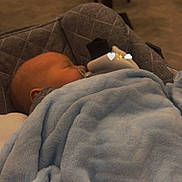 Arlo is registered to the contest to win money with this photo: baby, blanket, pacifier, sleeping, infant, sock, hand, manicure, carrier, cushion, soft, blue, cozy, indoor, person, child, resting, cute, calm, comfort