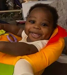 Clarence is registered to the contest to win money with this photo: baby, baby_products, cheek, child, comfort, eyebrow, forehead, fun, hair, happy, head, iris, joy, leisure, mouth, nose, person, room, sitting, skin