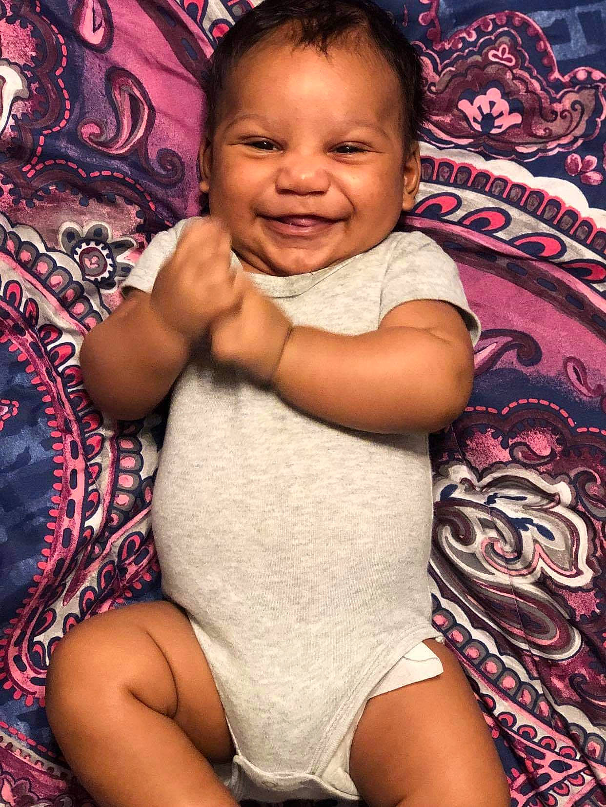 Johnnie is registered to the contest to win money with this photo: arm, baby, cheek, child, face, happy, head, joy, leg, person, sitting, skin, smile, thigh, toddler