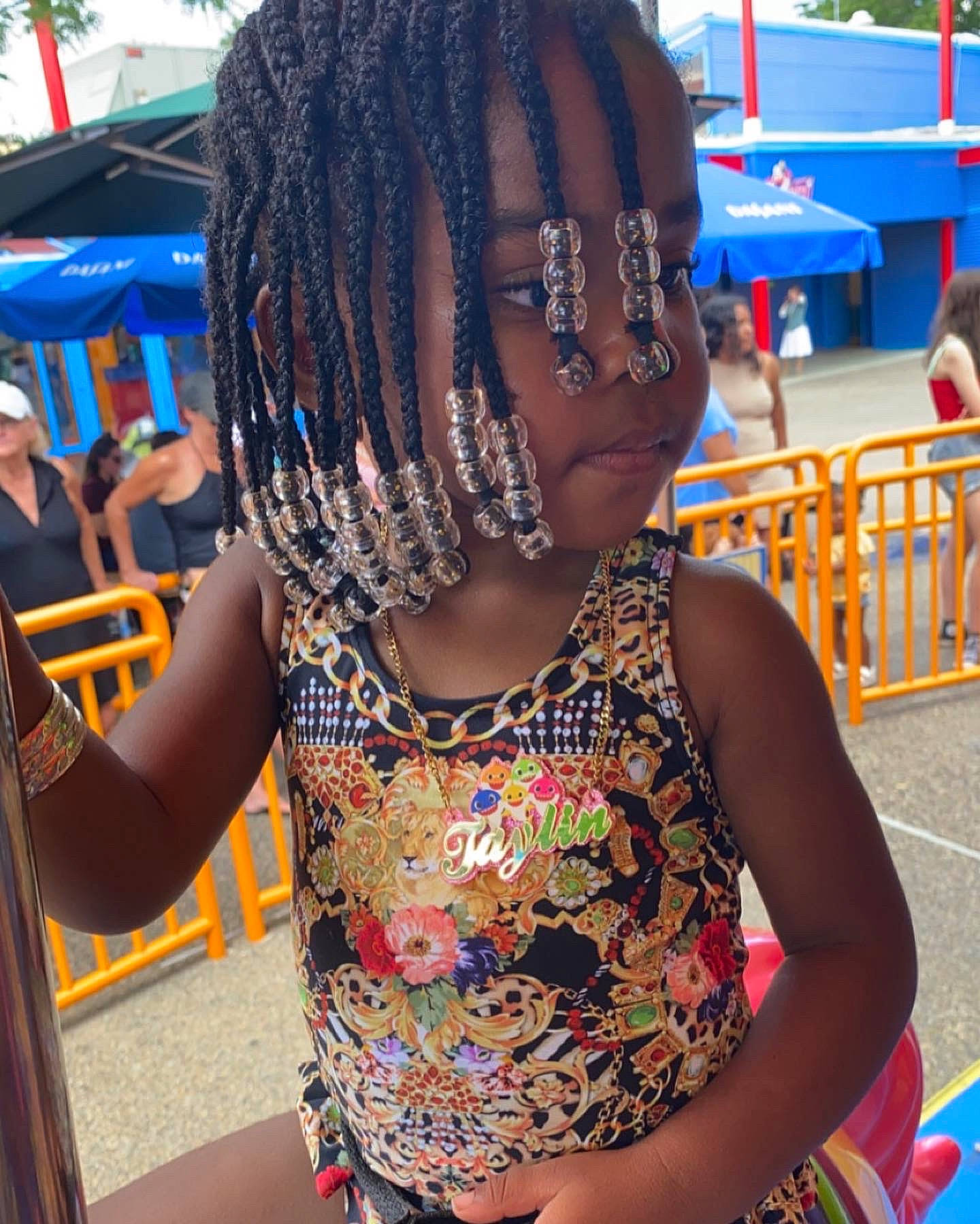 Taylin is registered to the contest to win money with this photo: art, black_hair, blue, blurred, braid, chair, child, cool, cornrows, dreadlocks, event, fashion_accessory, fun, happy, leisure, neck, pattern, person, snapshot, summer