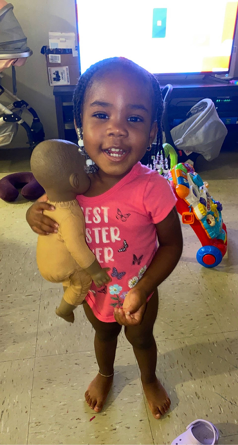 Taylin is registered to the contest to win money with this photo: baby_toddler_clothing, barefoot, child, clothing, finger, flooring, fun, gesture, happy, head, joint, joy, leg, nose, person, skin, smile, standing, t_shirt, thigh