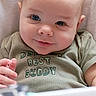 Danny joined the competition — help win amazing prizes! baby, infant, child, face, smiling, blue_eyes, clothing, shirt, text_on_clothing, blanket, portrait, cute, young_child, sitting, indoors, soft_lighting, close_up, person, happy, cozy