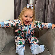 Dottie joined the competition — help win amazing prizes! toddler, child, smiling, happy, sitting, armchair, indoor, curtains, colorful_clothing, bow, blonde_hair, playful, cute, feet, sock, patterned_outfit, butterfly, young_child, joyful, portrait