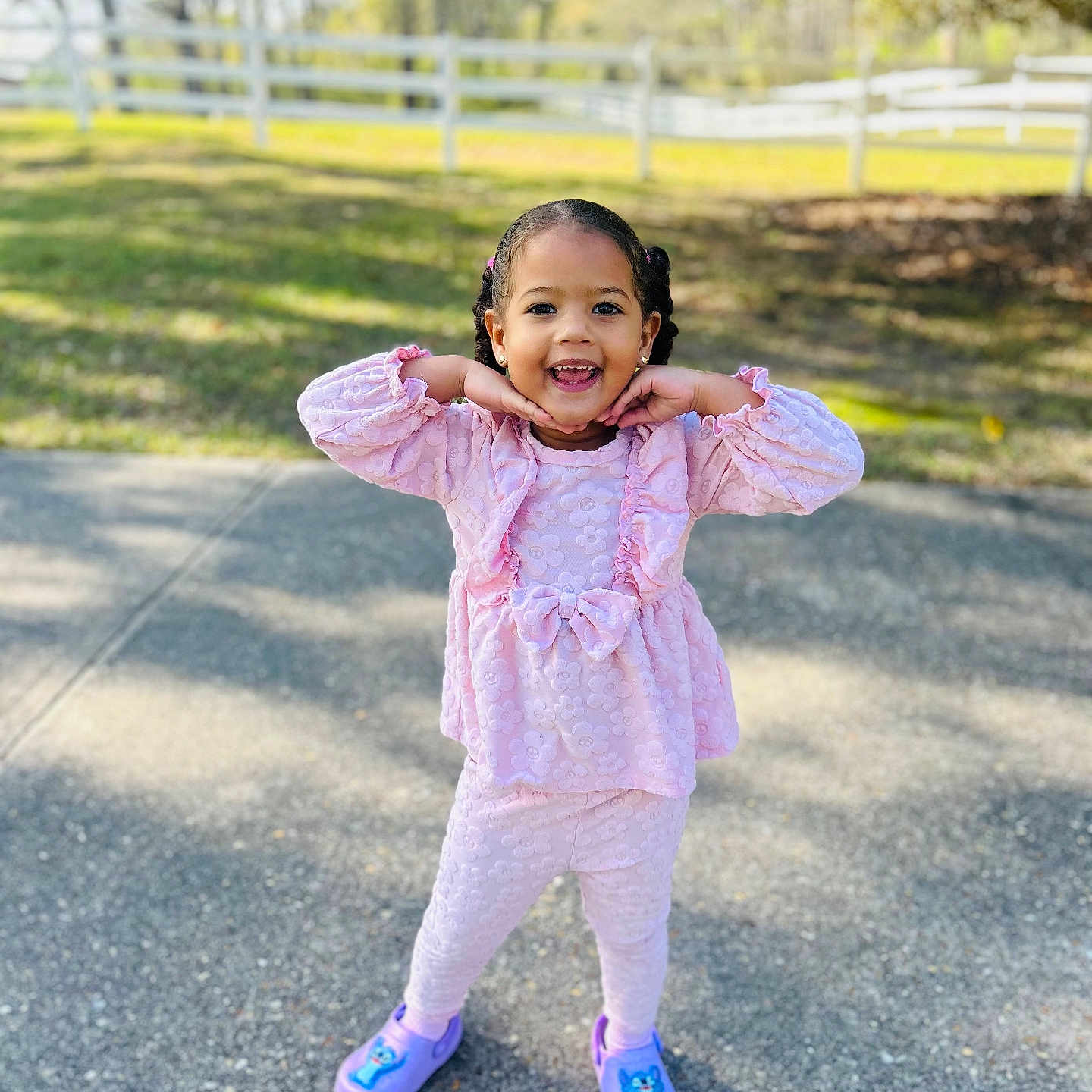 Chancy joined the competition — help win amazing prizes! child, toddler, pink_clothing, outdoor, smiling, playful_pose, paved_path, white_fence, greenery, sunny_day, happy, girl, casual_shoes, braided_hair, cute, daylight, portrait, fashion, young_child, nature