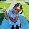 Chancy joined the competition — help win amazing prizes! child, girl, smiling, peace_sign, braided_hair, outdoor, sidewalk, sunlight, green_grass, casual_clothing, happy, playful, cute, portrait, daylight, person, shorts, tshirt, earrings, young