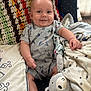 Kazdyn is registered to the contest to win money with this photo: baby, smile, drool, blanket, plush_toy, chair, clothing, cute, indoors, colorful, comfort, infant, happy, sitting, soft_toys, patterned_blanket, arm, leg, anklet, face