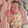 baby, blanket, child, closeup, comfort, cozy, cute, face, hair, hand, indoor, infant, newborn, onesie, pacifier, pink, rainbow_pattern, resting, sleeping, soft
