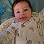 Brayleanna joined the competition — help win amazing prizes! baby, infant, onesie, floral_pattern, tongue_out, lying_down, blanket, pacifier, remote_control, cute, playful, person, child, soft_fabric, indoors, smiling, face, head, young, expression