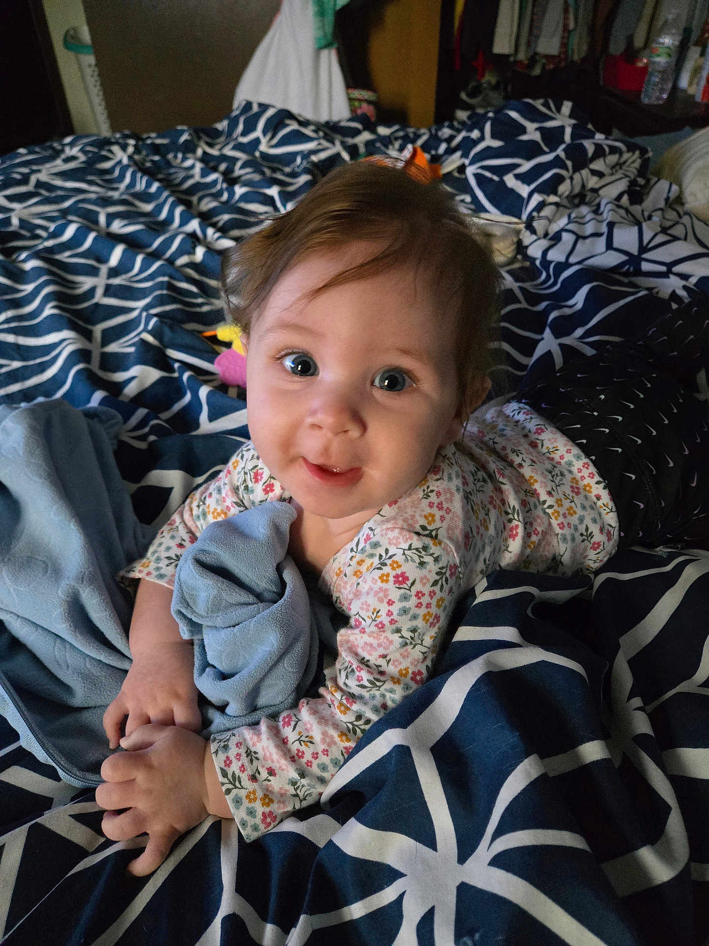 Brayleanna is registered to the contest to win money with this photo: baby, child, infant, bed, blanket, blue, clothing, cute, face, floral_pattern, hand, indoors, laying, person, plush, portrait, smiling, toy, young, sleepwear