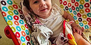 Brayleanna joined the competition — help win amazing prizes! baby, baby_seat, blanket, child, circles, clothing, colorful, comfort, face, floor, foot, happy, indoors, infant, pattern, person, portrait, seat, skin, smile