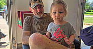 Brayleanna joined the competition — help win amazing prizes! child, man, sitting, indoor, garage, cap, tshirt, dog, sunlight, window, person, face, legs, chair, expression, casual, shorts, socks, hair, door