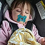 baby, blanket, car_seat, child, comfort, cute, face, hoodie, indoors, infant, pacifier, peaceful, person, pink_clothing, resting, safety, seatbelt, sleeping, toddler, young_child