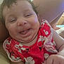 Brayleanna joined the competition — help win amazing prizes! baby, cheeks, child, closeup, cute, face, floral_pattern, funny_expression, hand, happy, indoor, infant, person, portrait, red_clothing, sitting, skin, smiling, soft_light, tongue_out