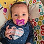 Brayleanna is registered to the contest to win money with this photo: baby, pacifier, blue_clothing, heart_patch, polka_dot, baby_seat, colorful_pattern, lion_illustration, hand, face, eyes, hair, indoors, child, cute, portrait, infant, cozy, fabric, soft