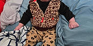 Brayleanna joined the competition — help win amazing prizes! baby, blanket, blue, bow, child, clothing, couch, cute, expression, face, feet, hand, indoor, infant, leopard_print, pants, pink_socks, portrait, sitting, vest