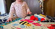 Brayleanna is registered to the contest to win money with this photo: bed, blanket, book, child, clothing, colorful, furniture, happy, indoor, person, pigtails, playtime, portrait, reading, room, smile, toddler, towels, toy, wooden_door