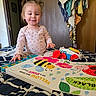 Brayleanna is registered to the contest to win money with this photo: toddler, child, book, toy, bed, blanket, pigtails, indoor, smile, clothing, furniture, wooden_door, towels, colorful, playtime, portrait, happy, person, room, reading