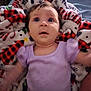 Brayleanna is registered to the contest to win money with this photo: baby, child, infant, purple_clothing, blanket, patterned_blanket, face, eyes, lying_down, soft_texture, indoor, cute, young_child, sleepwear, cozy, portrait, expression, person, skin, head
