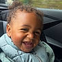 baby, car, car_seat, child, clothing, curly_hair, cute, face, happy, jacket, person, portrait, rain, seatbelt, side_mirror, smile, toddler, vehicle_interior, window, young_child