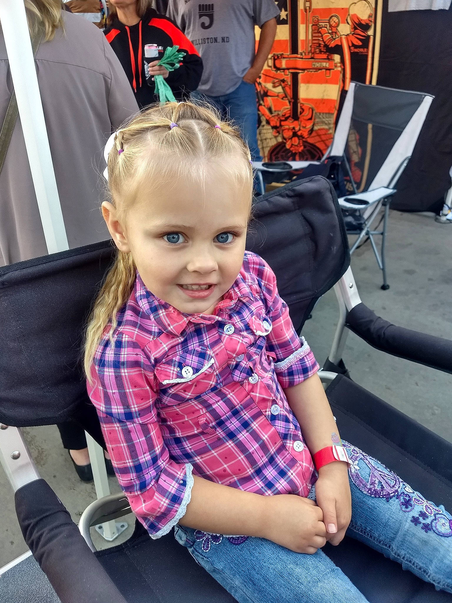 Jorja is registered to the contest to win money with this photo: child, design, ear, hairstyle, joy, pattern, person, plaid, sitting, smile, toddler, vacation