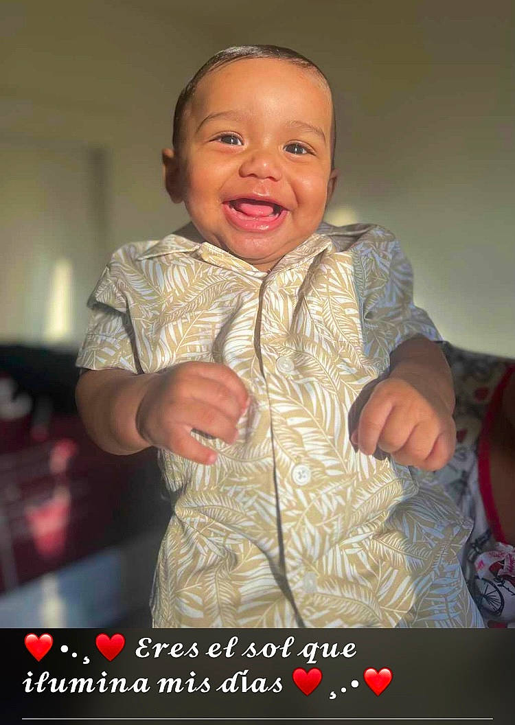 Ian Manuel Florentino is registered to the contest to win money with this photo: baby, baby_products, baby_toddler_clothing, cheek, child, finger, flash_photography, gesture, hand, happy, laugh, mouth, person, photo_caption, room, sitting, sleeve, smile, t_shirt, thumb