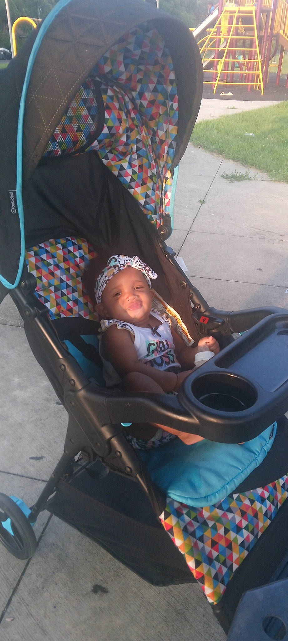 Makayla is registered to the contest to win money with this photo: auto_part, baby, baby_carriage, baby_products, baby_safety, baby_toddler_clothing, chair, child, comfort, electric_blue, fun, headwear, lap, leisure, person, plant, sitting, tire, toddler, travel