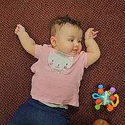 Amber joined the competition — help win amazing prizes! baby, child, pink_shirt, cat_design, carpet, toy, colorful_toy, navy_pants, curly_hair, earrings, lying_down, arms_up, feet, brown_shoes, floor, indoor, cute, infant, person, casual_clothing