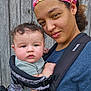 baby, baby_carrier, bonding, casual_clothing, closeup, curly_hair, drool, expression, face, fence, head, headband, mother_and_child, outdoor, person, portrait, shoulder, skin, woman, wood