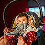 baby, child, car_seat, curly_hair, striped_cloth, red_pants, polka_dots, barefoot, indoor, sunlight, cute, infant, person, portrait, seat, toy, comfort, soft_toys, head, hand