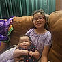 Savannah joined the competition — help win amazing prizes! baby, blanket, brown_couch, child, couch, cozy, curly_hair, cute, family, glasses, holding, homedecor, indoor, polka_dot, portrait, purple_dress, relaxing, seated, sibling, smile