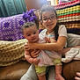 Savannah joined the competition — help win amazing prizes! baby, blanket, braid, child, colorful_clothing, couch, cozy, crocheted_blanket, fabric, furniture, glasses, happy, holding, home, indoor, infant, person, sitting, smiling, toddler