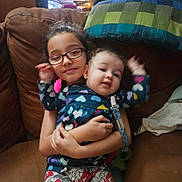 Savannah joined the competition — help win amazing prizes! affection, arm_raise, baby, blanket, child, clothing, couch, cute, family, glasses, happy, heart_pattern, holding, home, indoors, person, pillow, sitting, smile, toddler