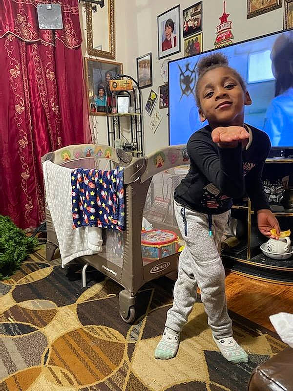 K'Niyah is registered to the contest to win money with this photo: baby, bag, carpet, curtain, event, flooring, fun, leisure, luggage_and_bags, person, picture_frame, plant, retail, room, shopping, sitting, smile, t_shirt, toddler, visual_arts