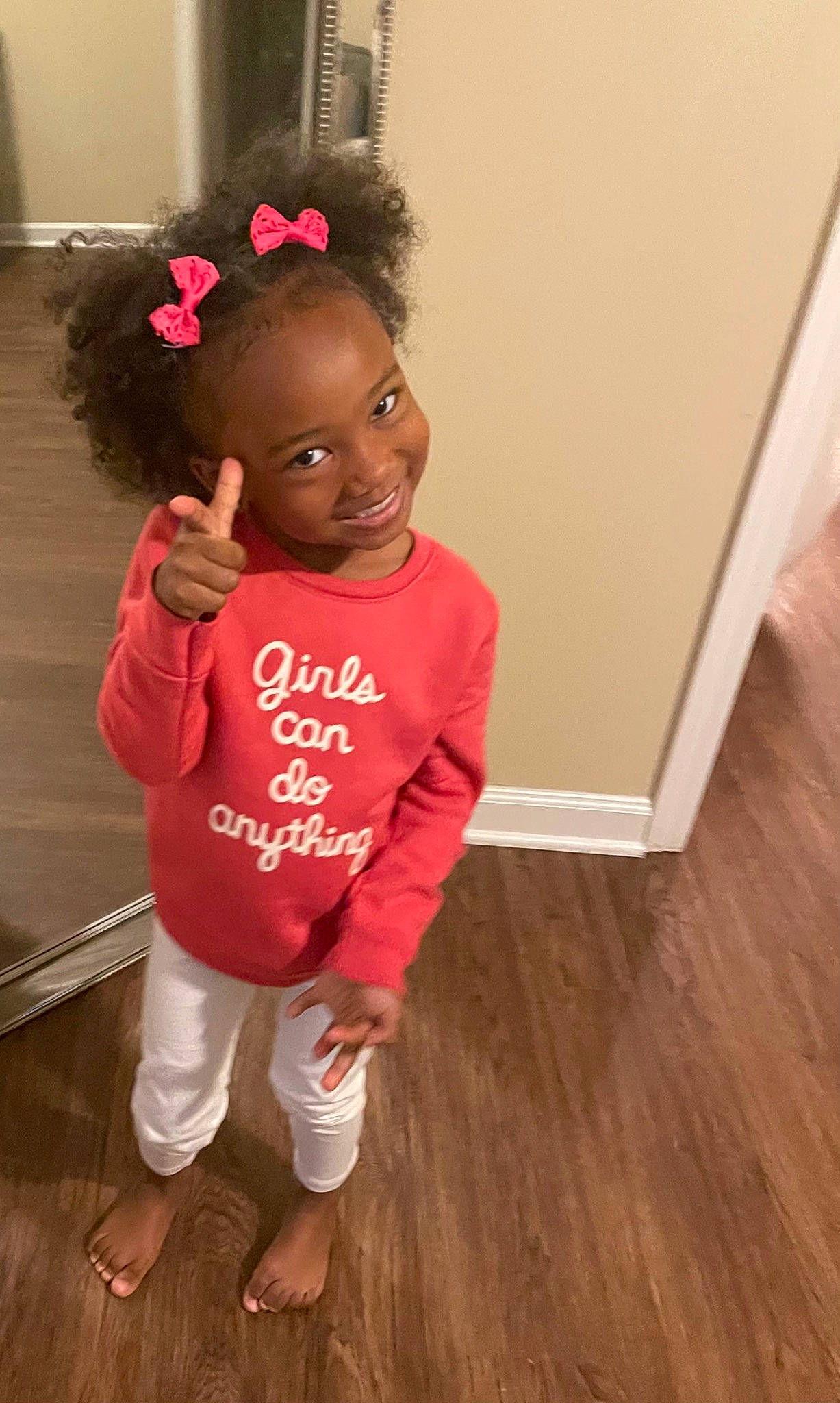 Kinley joined the competition — help win amazing prizes! baby_toddler_clothing, child, flooring, hair, happy, hardwood, head, human_leg, joy, magenta, pattern, person, sandal, skin, sleeve, smile, t_shirt, thigh, toddler, varnish