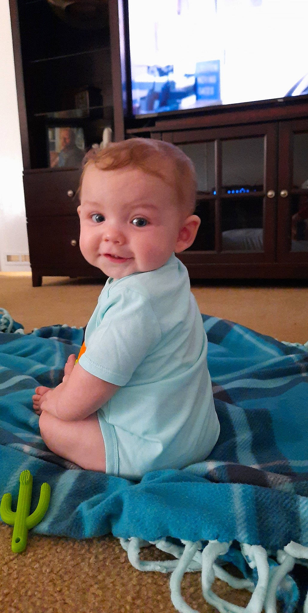 Austyn is registered to the contest to win money with this photo: baby, cheek, child, eye, face, head, person, sitting, skin, smile, toddler, tummy_time, vacation